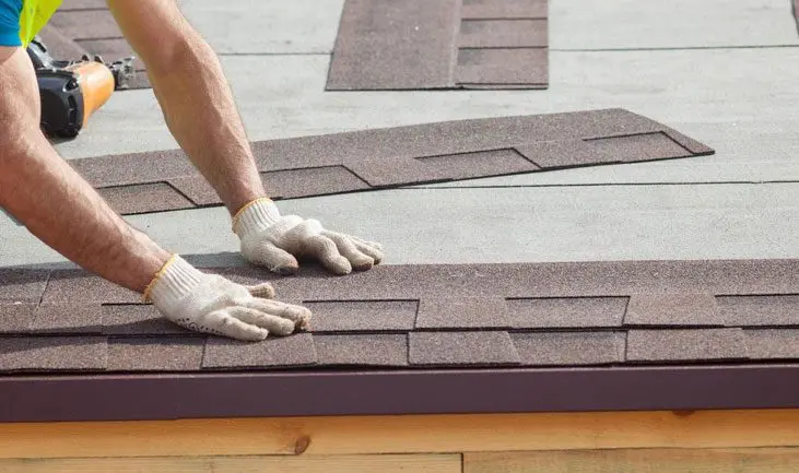 A person is working on the roof of a house.