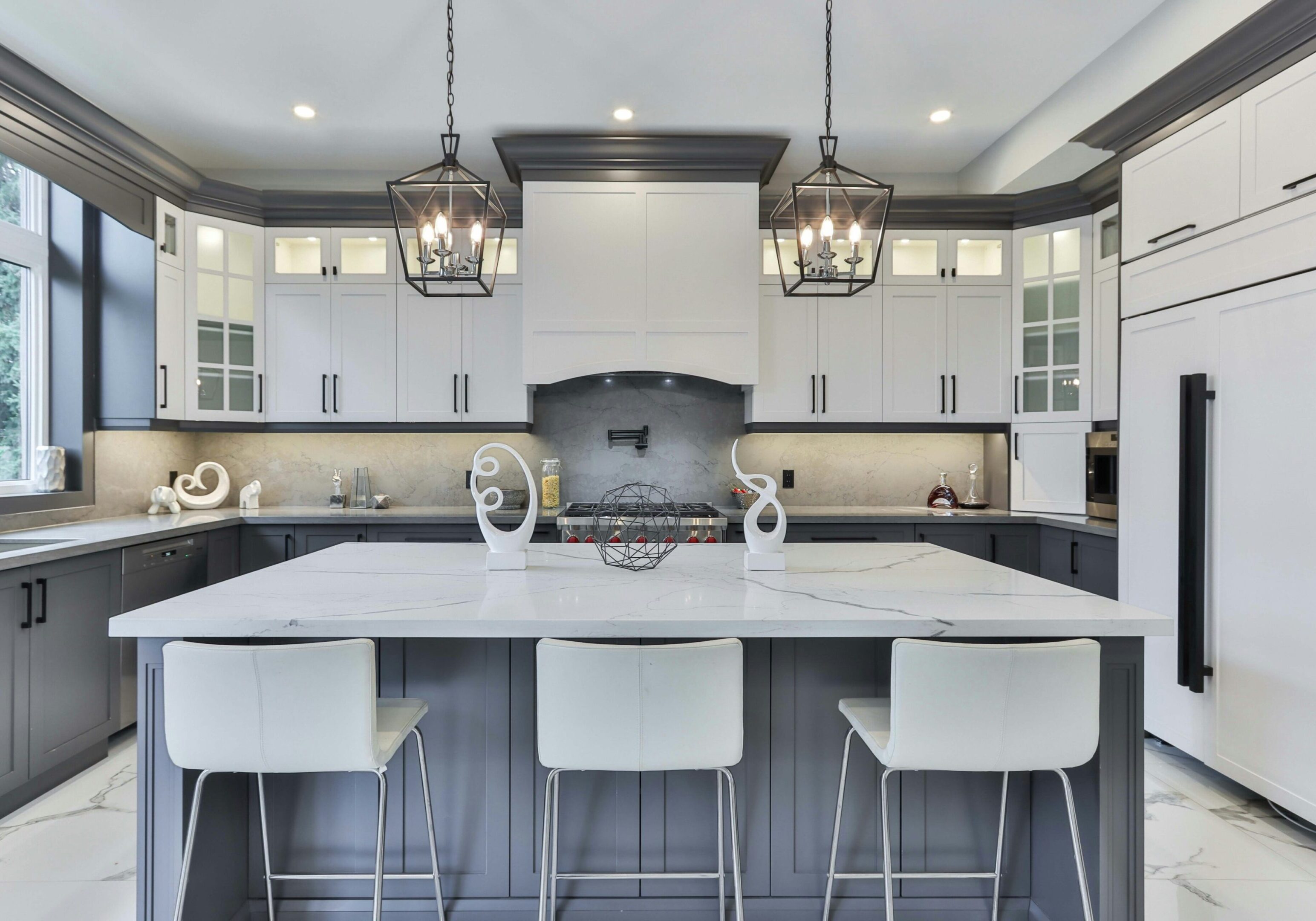 A kitchen with white cabinets and black accents